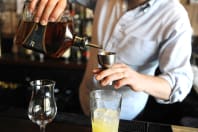 A man pouring a cocktail during a cocktail making class