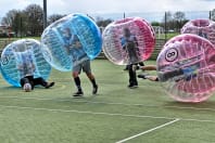 A laughing stag group play zorb footballl