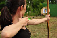 A member of a hen group doing archery