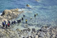 A group of people doing coasteering