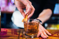 A man pouring a cocktail during a cocktail making class