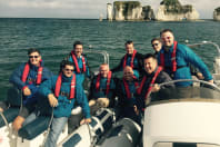 A group of happy guys power boating