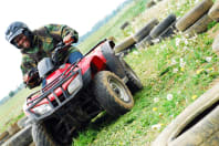 A happy man laughing on a quad bike