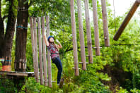 A woman having fun on a high ropes course