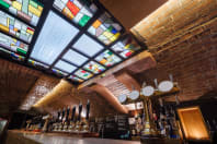 The Beer Emporium Bristol taps and stained glass ceiling