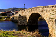 Roman bridge of 125 meters long built on the river Tormes in the town "El Barco de Ávila" in Spain