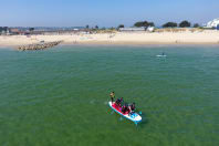 A group of men on a jumbo paddleboard