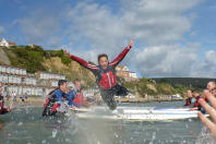 Jumping off a paddleboard in Bournemouth