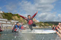 Jumping off a paddleboard in Bournemouth