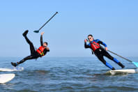 Stag group falling off a paddleboard into the sea