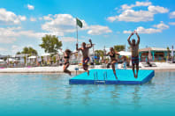 Lake Lupa Premium Beach group of friends jumping into sea