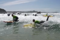 A GROUP OF SURFERS IN WATER
