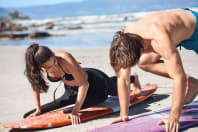 woman having surf lessons on the beach