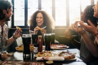 friends enjoying pizza meal in restaurant