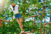 woman climbing high ropes