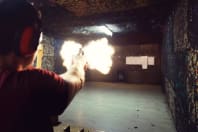 A man shoots a gun a shooting range sharper
