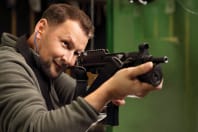 A man shoots a gun a shooting range