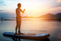 man paddle boarding in lake