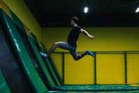 trampoline jumper performs complex acrobatic exercises and somersault on the trampoline