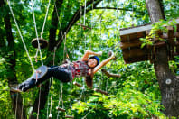 A woman having fun on a high ropes course