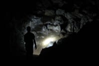 person climbing in cave