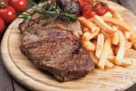 A plate of steak and chips