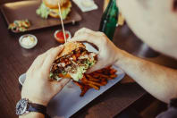 A man holds a burger