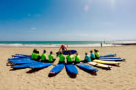 A hen group having a surfing lesson on a Bournemouth beach