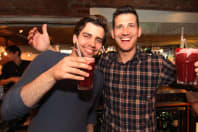 Two happy members of a stag party making cocktails