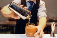 A man pours cocktails