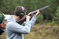 A man shoots clay pigeons