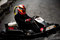 A group of people racing go karts around a track