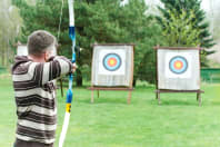 Person shooting bow and arrow in archery
