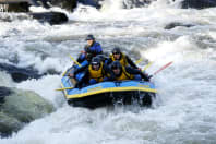 A stag party travel down rapids white water rafting