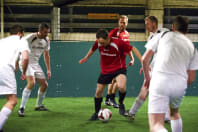 A group of men playing five-a-side footba