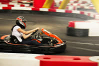 A group of people racing go karts around a track