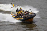 A group riding a thames rib speedboat