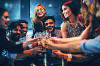 Group of friends laughing and clinking champagne glasses -  VIP tables