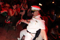 A male stripper does a dance on a hen party