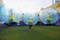 a happy hen party playing zorb football