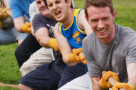 A group of men playing tug of war
