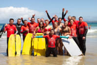 A happy group enjoying a body boarding lesson