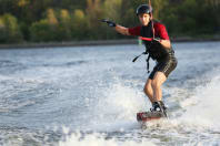 wake boarder doing wake boarding on a cable