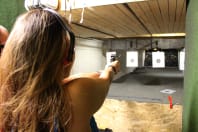 A woman firing a pistol