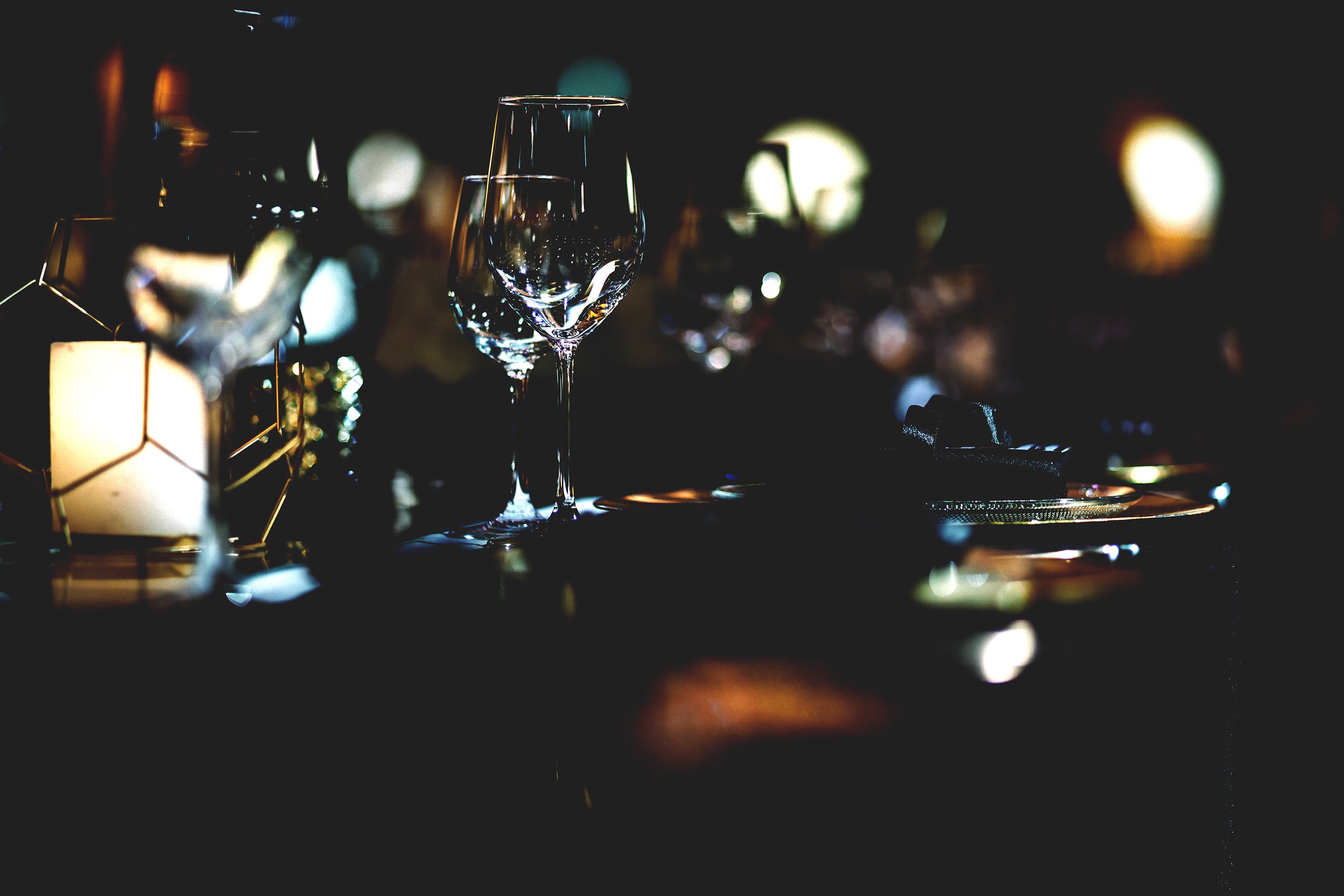 Dinner in the dark bokeh effect glasses dim lighting romantic feel