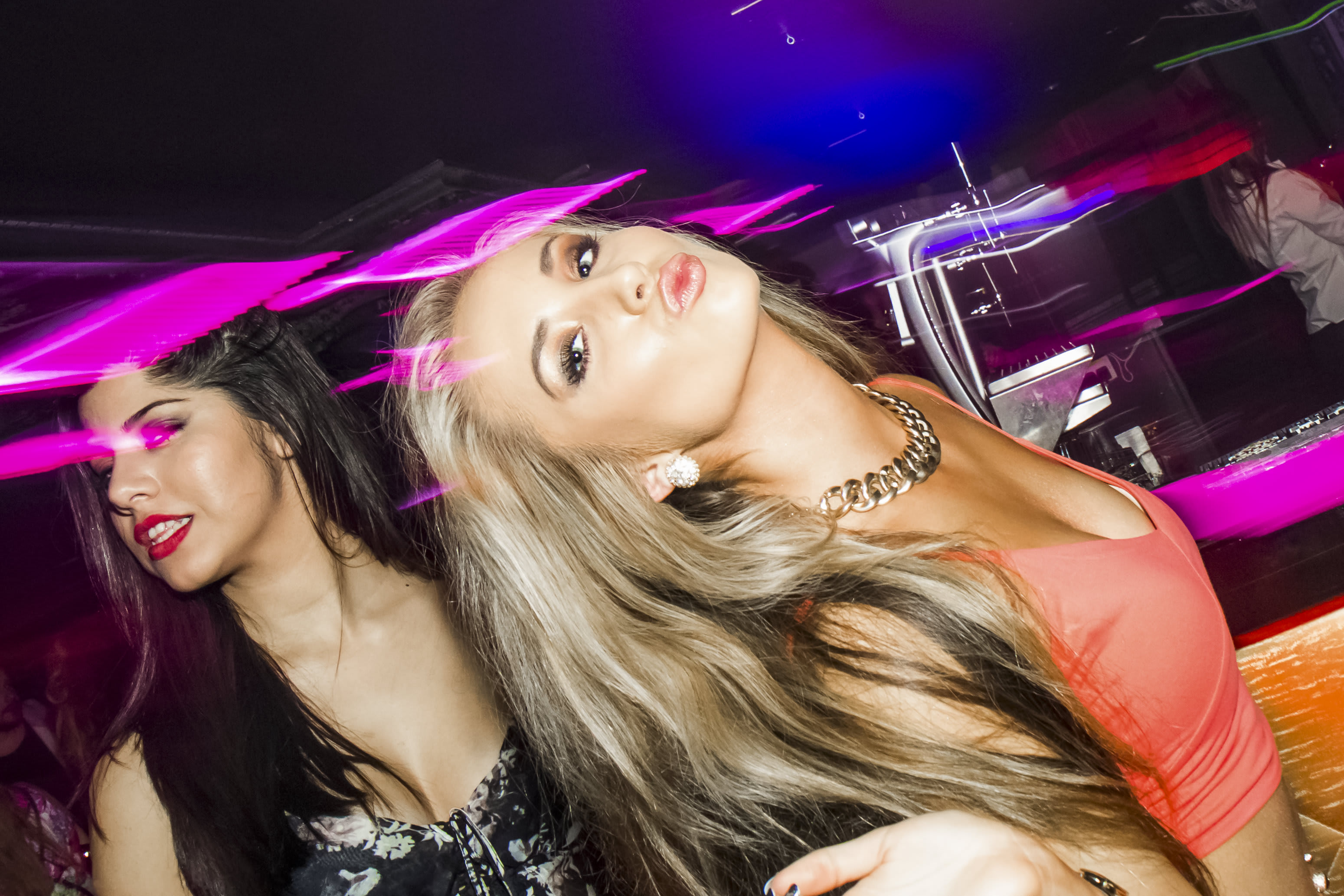 Two attractive girls having fun in a nightclub