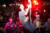 A woman dances on the bar during a bar crawl