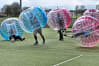 A laughing stag group play zorb footballl