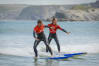 Two guys surfing