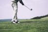 A golfer hitting a ball